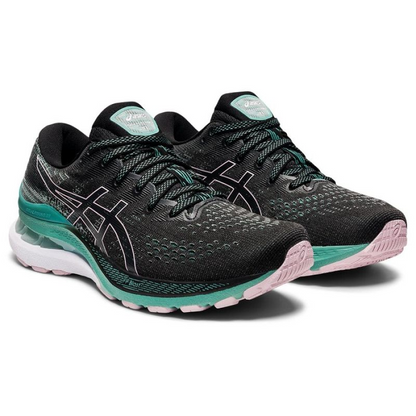 Asics Gel Kayano 28 W running shoes in black and white with cushioned soles and mesh upper, displayed on a neutral background.