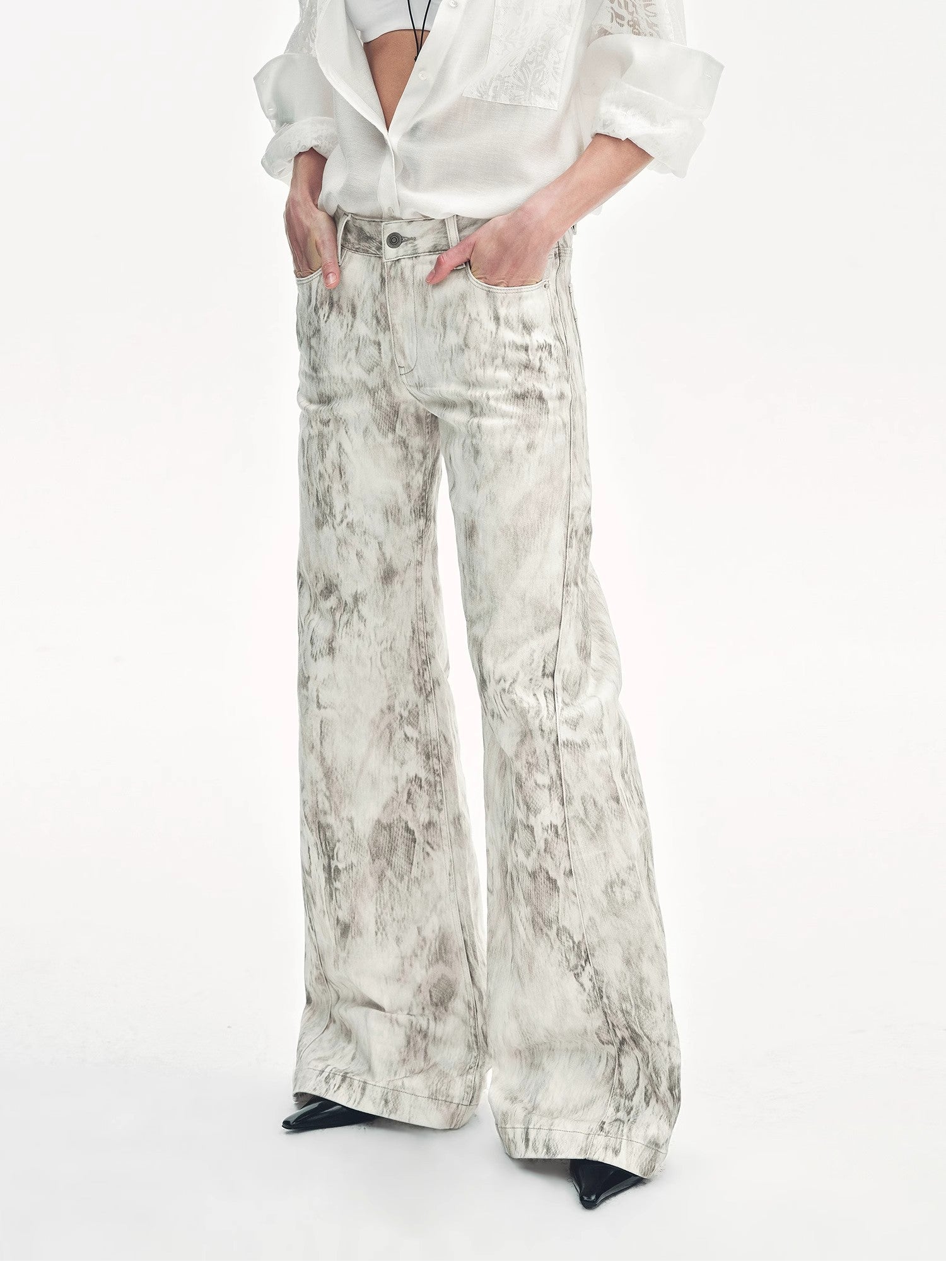 Brown Coeus "Phantom" snake print flared denim trousers with a distinctive snake pattern and flared leg design.