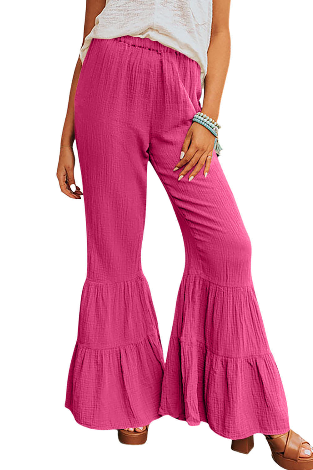 Rose textured high waist ruffled bell bottom pants by Carmine Juneberry, showcasing the floral fabric and flowing silhouette.