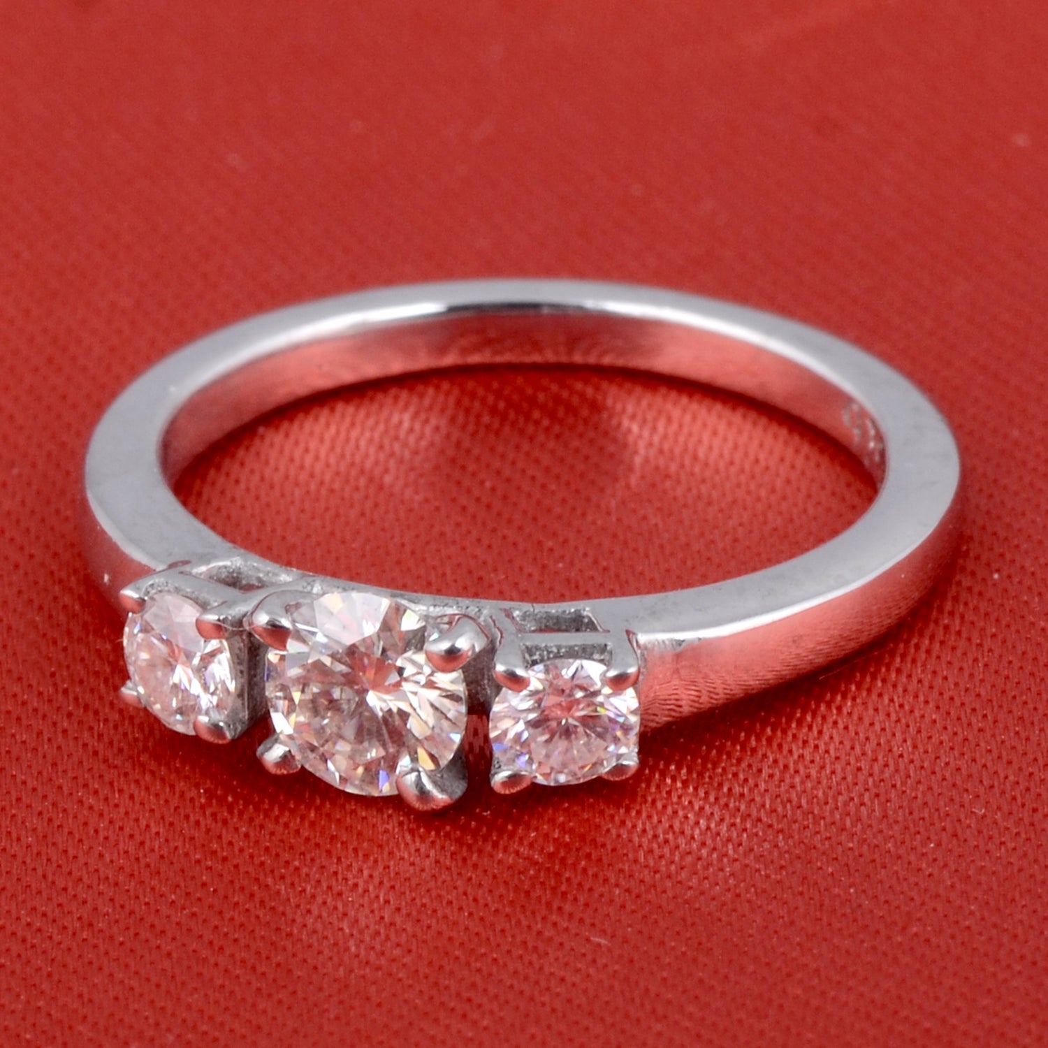 Sterling silver white moissanite 3-stone ring with sparkling gemstones, elegant jewelry design, crafted by Copper Juniper.