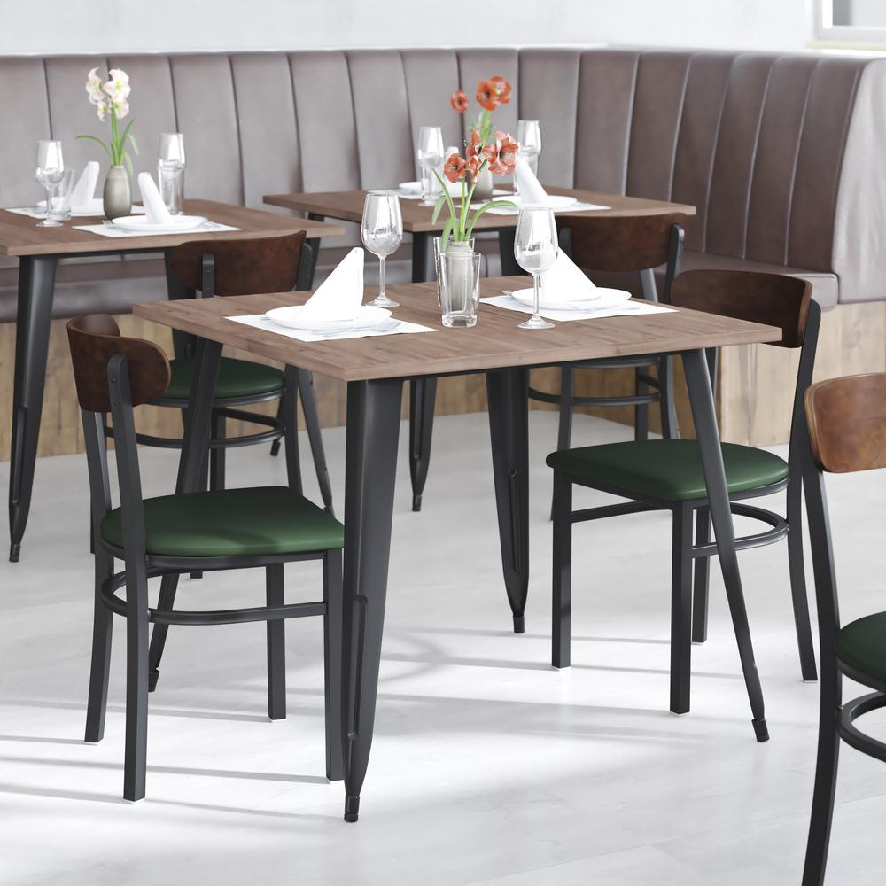 Start2Finish commercial dining chair with vinyl upholstered seat and wood boomerang back, shown in a modern restaurant setting.