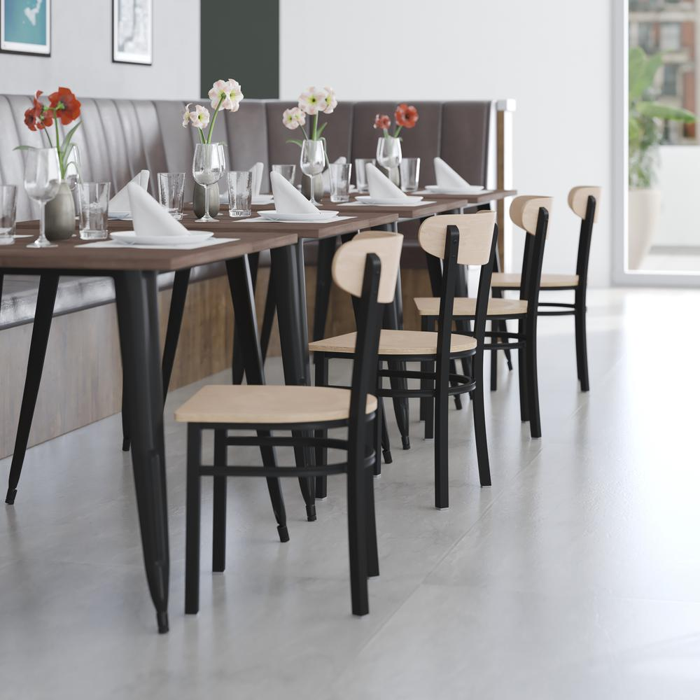 Commercial dining chair with vinyl upholstered seat and wood boomerang back, featuring a sturdy frame and stylish design.