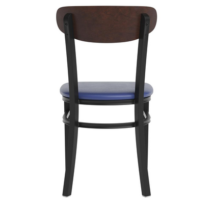 Commercial dining chair with vinyl upholstered seat and wood boomerang back, by Start2Finish, shown in a modern restaurant setting