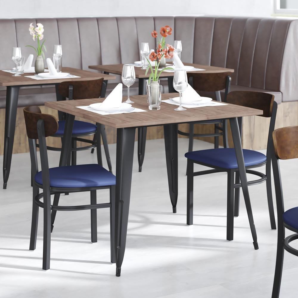 Commercial dining chair by Start2Finish with vinyl upholstered seat and wood boomerang back for restaurant or cafe furniture.
