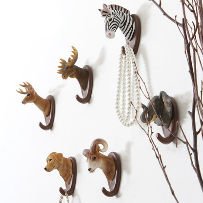 Fuchsia Molly animal wall hook mounted on a wooden wall, decorative home and garden accessory with a playful animal design.