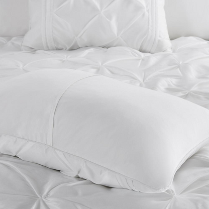 Start2Finish Laurel 7-piece white tufted comforter bedding set with matching pillow shams and decorative accents.