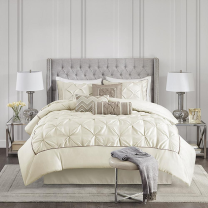 Start2Finish Laurel 7-piece tufted comforter set in ivory with matching pillow shams and decorative pillows on a bed.