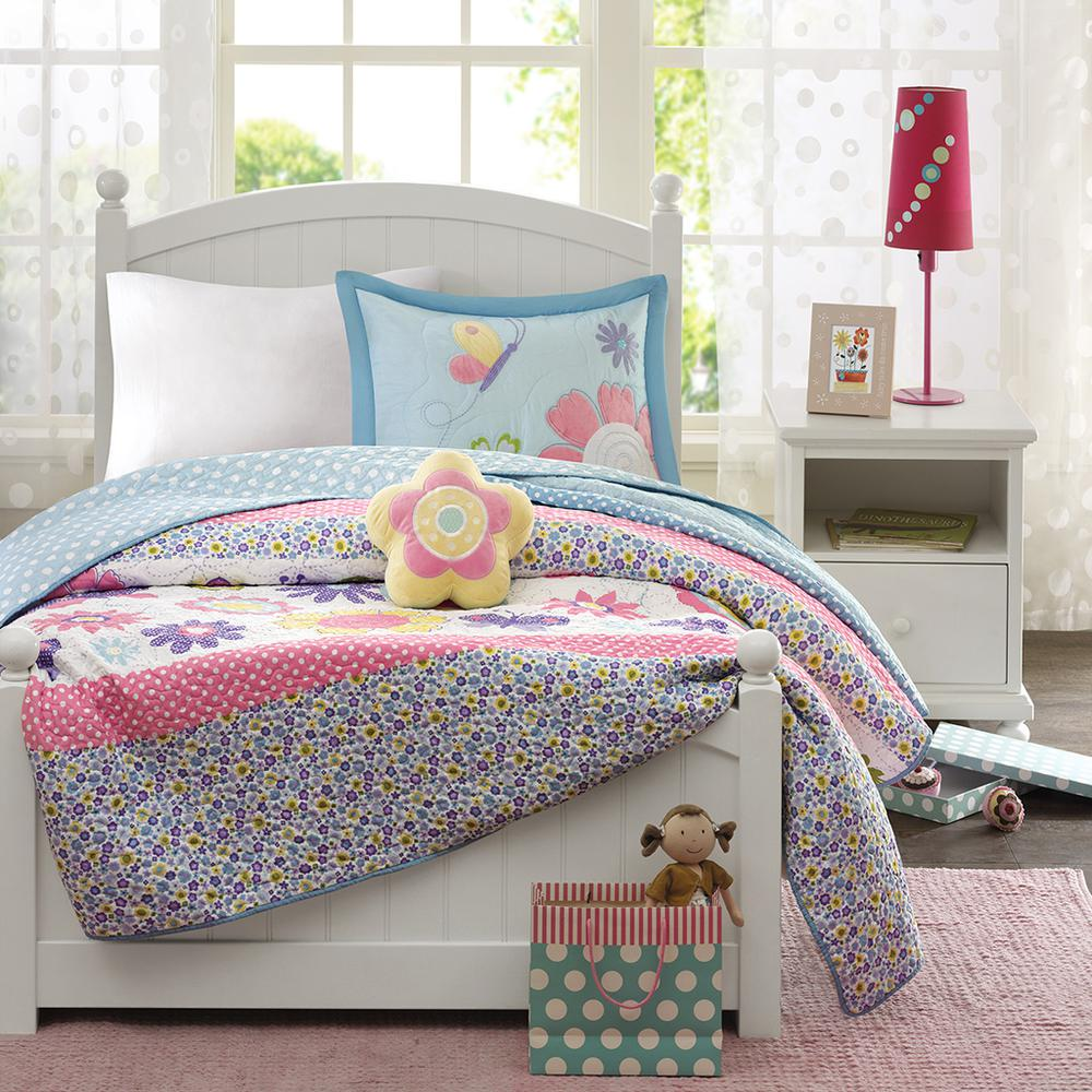 Reversible quilt set with matching throw pillow from Start2Finish, featuring colorful, patterned bedding on a neatly made bed.