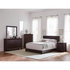 Brown Dorian upholstered full panel bed by Start2Finish with a padded headboard and sleek design, shown in a bedroom setting.