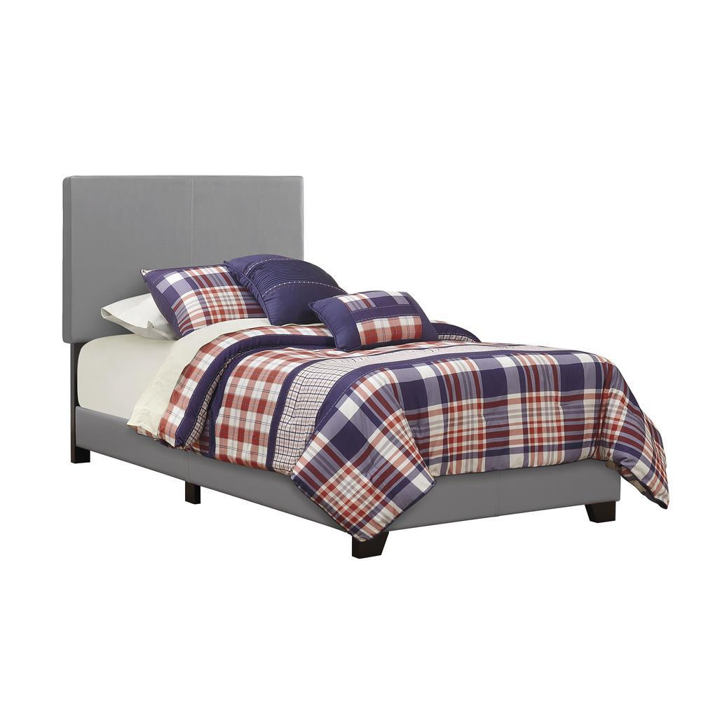 Grey Dorian upholstered twin panel bed by Start2Finish with a padded headboard and sleek wooden frame, shown in a modern bedroom setting.