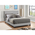 Start2Finish Dorian upholstered queen panel bed in grey with a padded headboard and sleek wooden frame, shown in a modern bedroom setting.
