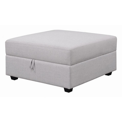 Grey upholstered Cambria Square Storage Ottoman by Start2Finish with cushioned top and built-in storage space.