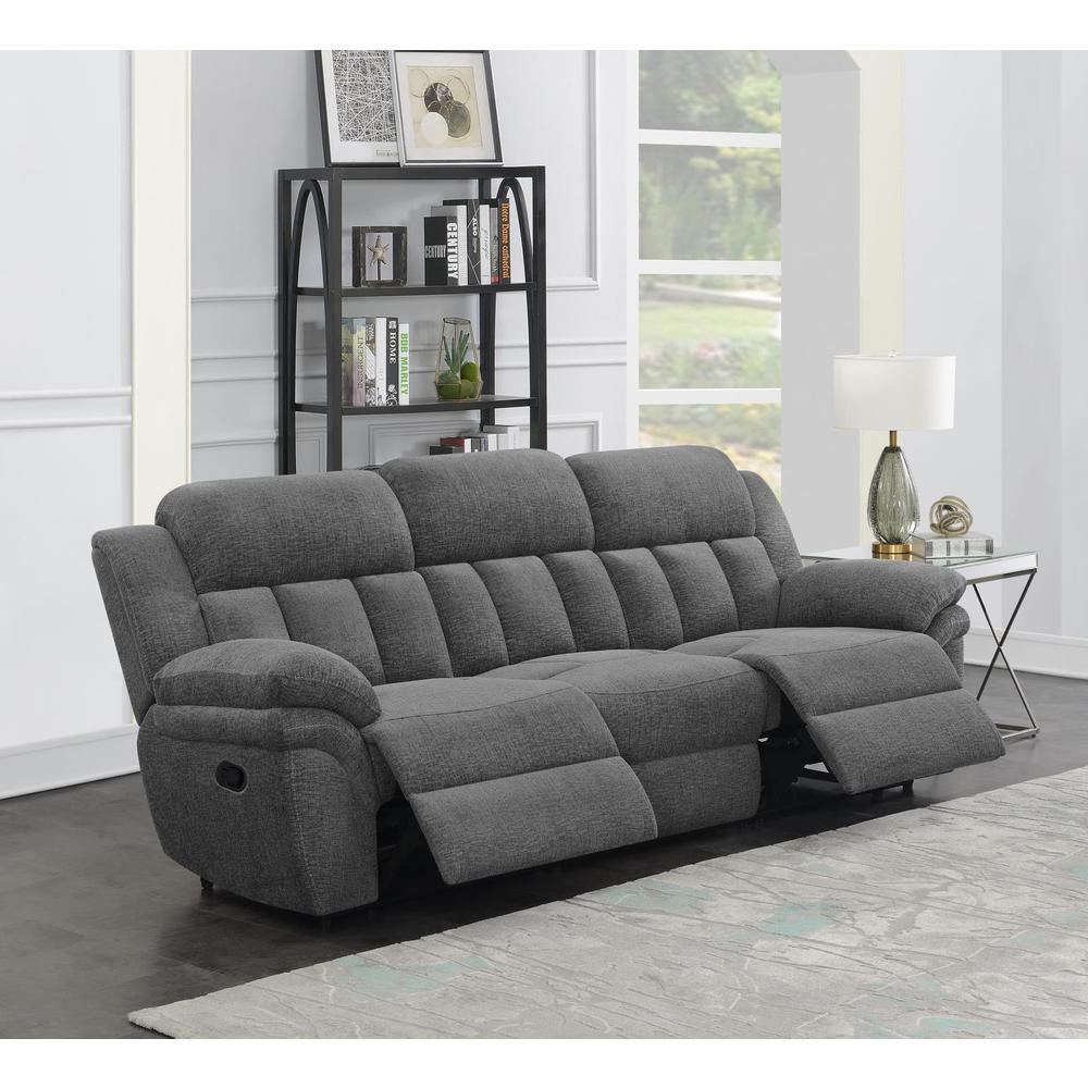 Charcoal Bahrain upholstered motion sofa by Start2Finish with plush cushions and modern design, shown in a living room setting.