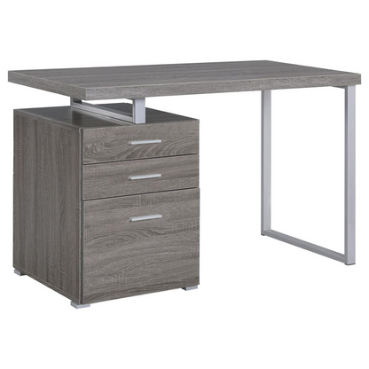 Weathered grey Brennan 47-inch office computer desk with 3 drawers, made by Start2Finish, shown with a sturdy wooden surface and storage compartments.