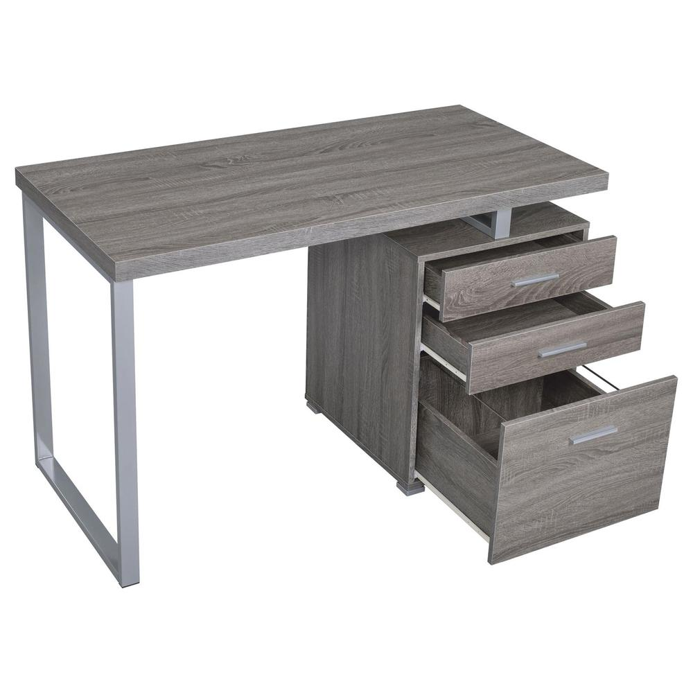 Weathered grey Brennan 47-inch 3-drawer office computer desk by Start2Finish, showing its sturdy wood surface and modern design.