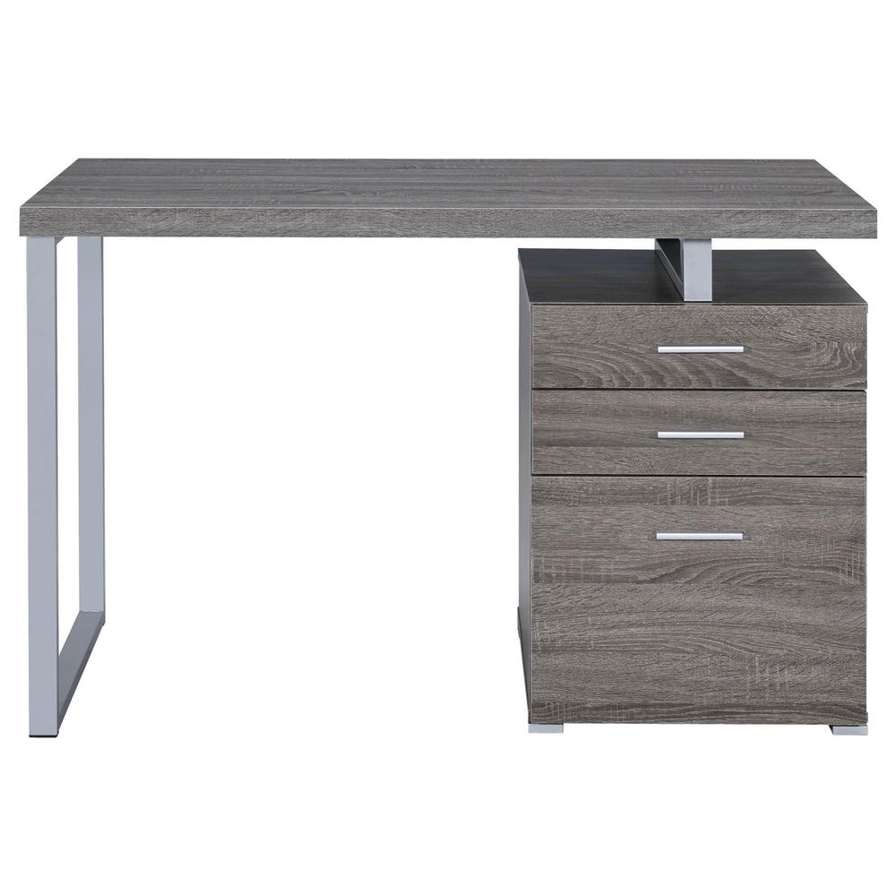 Weathered grey Brennan 47-inch 3-drawer office computer desk by Start2Finish, showing sturdy wood surface and sleek drawer handles.