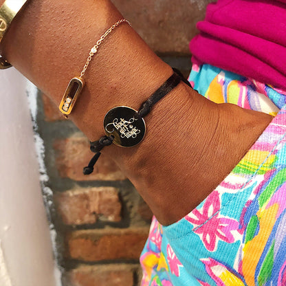 Black Girl Magic bracelet from Sky Blue Iapetus, featuring a stylish black and gold design with empowering text.