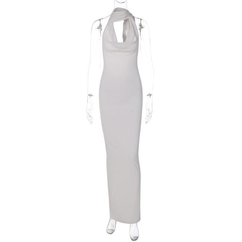 Green Alcestis skincare product, slim backless halter neck dress with elegant design, displayed on a neutral background.