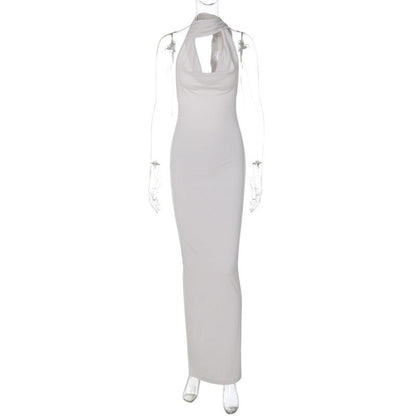 Green Alcestis skincare product, slim backless halter neck dress with elegant design, displayed on a neutral background.