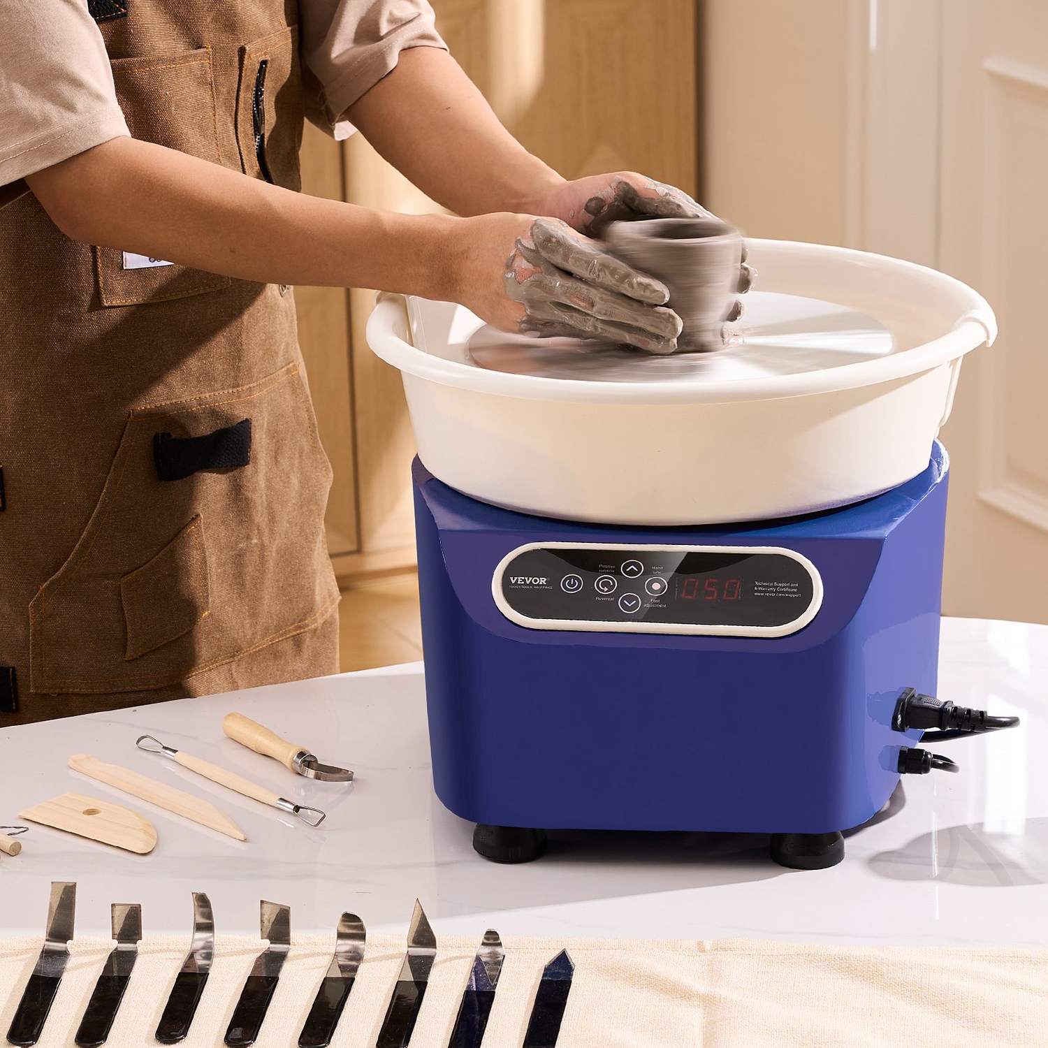 Blue VEVOR pottery wheel with LCD touch screen, foot pedal, and shaping tools for DIY ceramic art and pottery crafting.