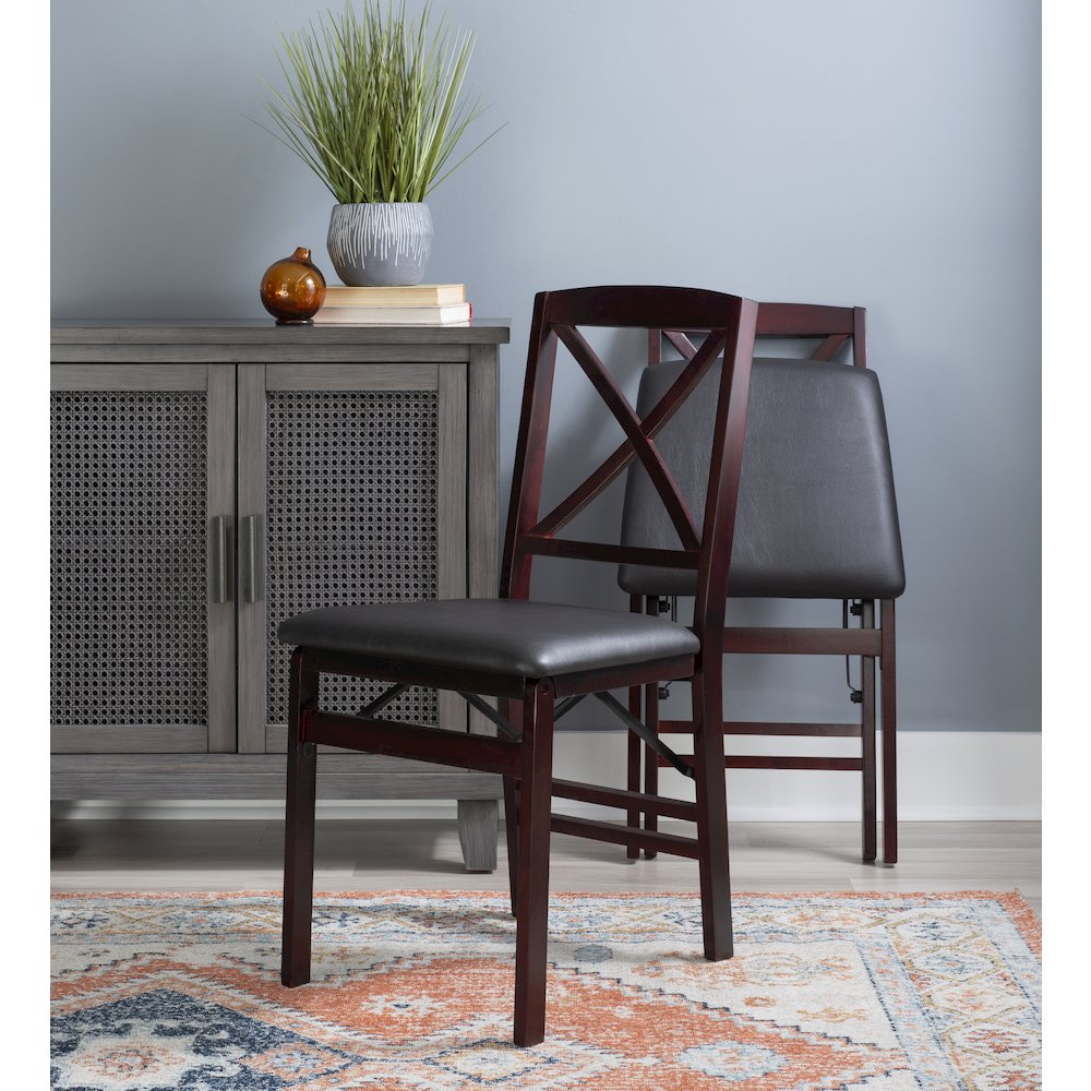Two Triena 18-inch X-back folding chairs from Start2Finish, featuring wooden seats and metal frames, set side by side.
