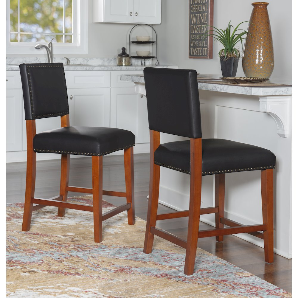 Black Brook counter stool by Start2Finish with a sleek design and cushioned seat, shown from the side with wooden legs.