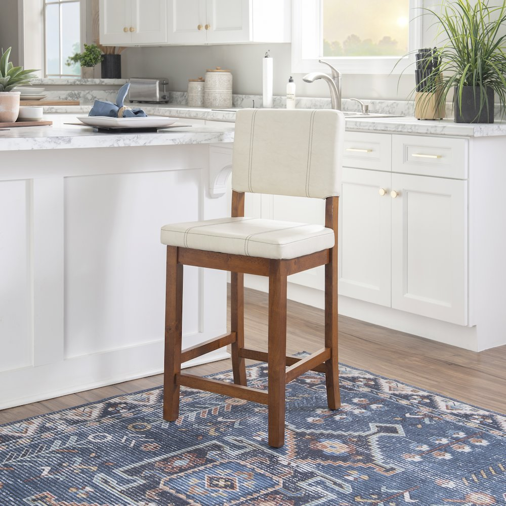 Cream Milano counter stool by Start2Finish with a cushioned seat and wooden legs, suitable for kitchen or bar area seating.