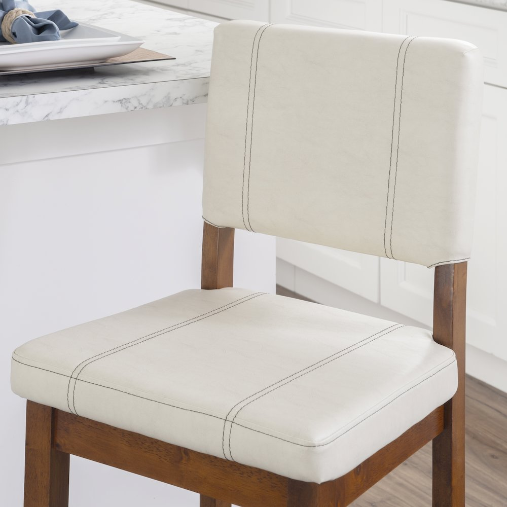 Milano counter stool by Start2Finish featuring a cream upholstered seat with dark wooden legs, modern and stylish design.