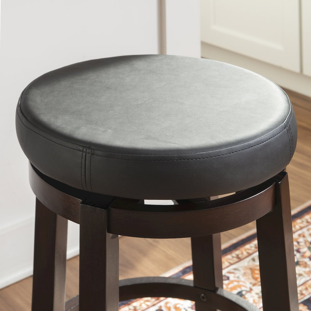 Black Maya 24-inch counter stool by Start2Finish featuring a modern design with a cushioned seat and sturdy wooden legs.