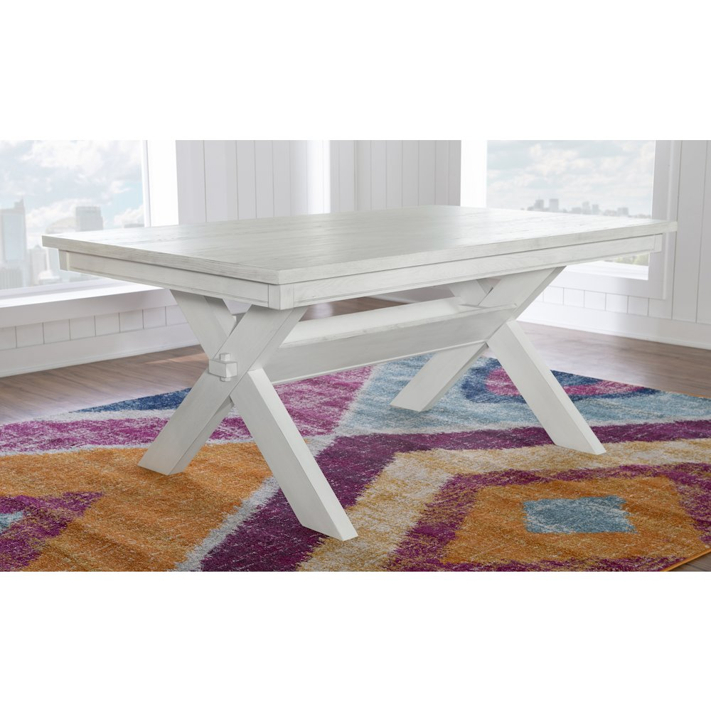 Distressed white dining table from Start2Finish, with a rustic wooden surface and sturdy legs, ideal for a farmhouse-style dining room.