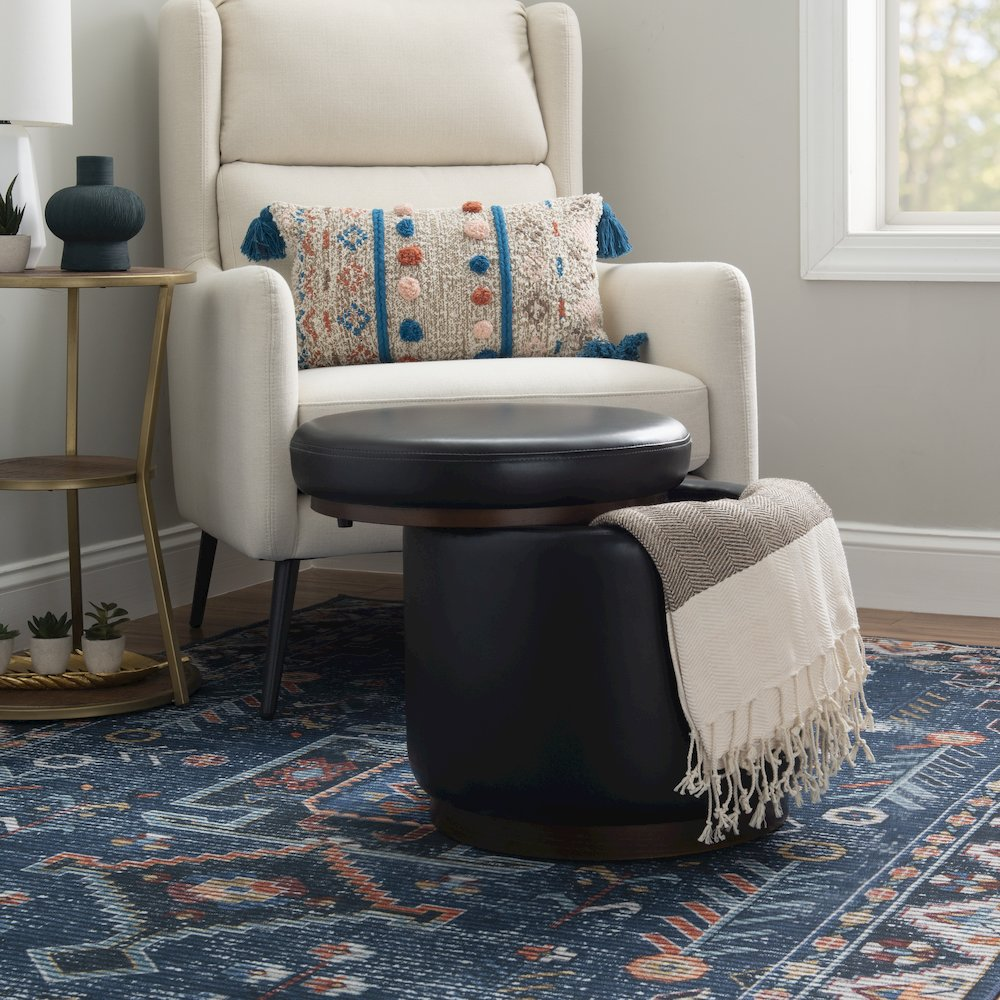 Black faux leather Blanche Storage Ottoman by Start2Finish with a cushioned lid and spacious interior for extra storage.