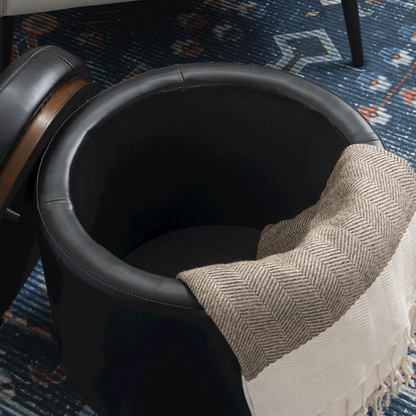 Black PU Blanche storage ottoman by Start2Finish with a cushioned top and sleek design, shown in a living room setting