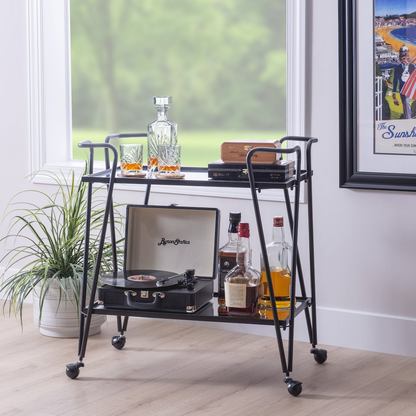 Black mid-century bar cart by Start2Finish, featuring two tiers, metal frame, and castered wheels for stylish beverage serving.
