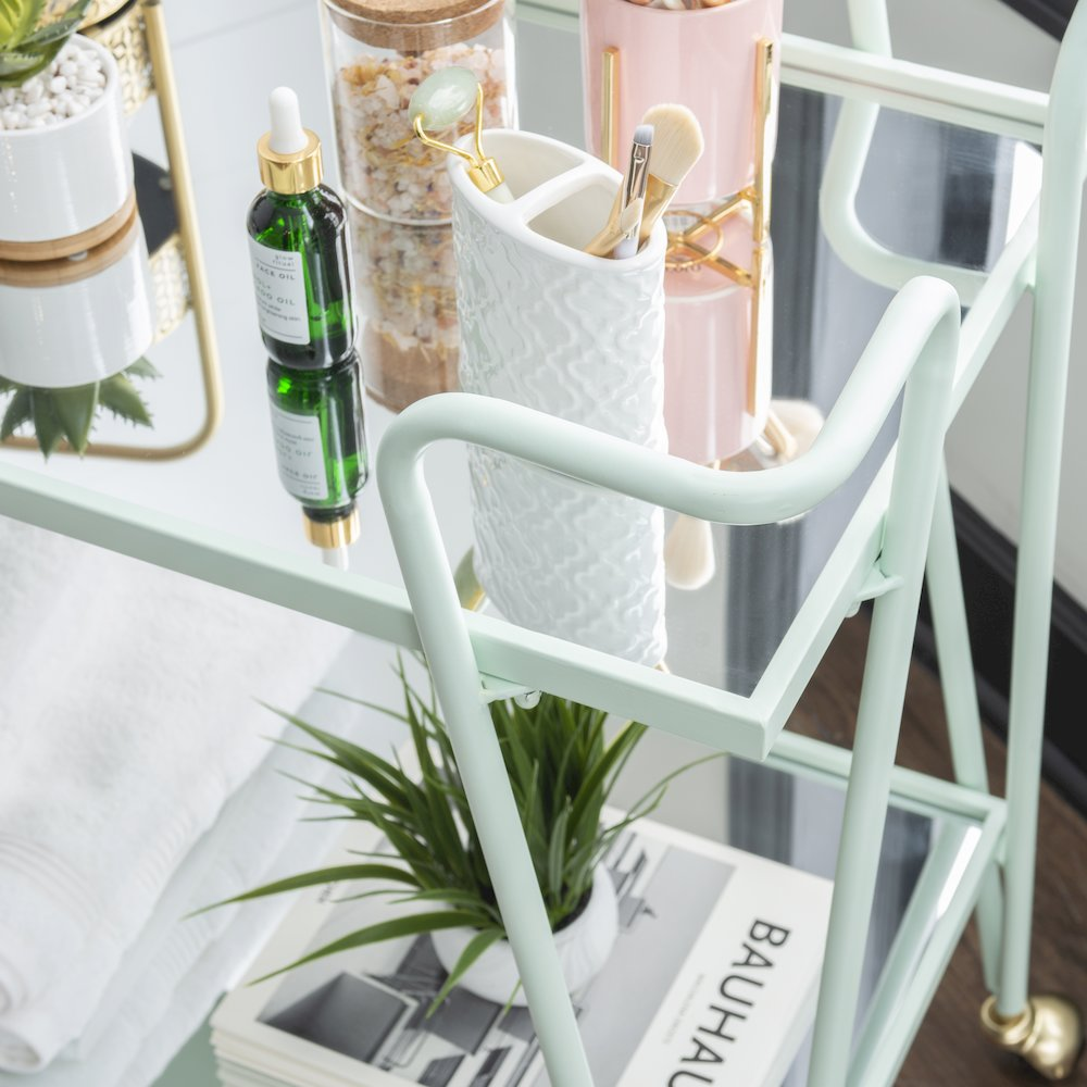 Mint mid-century bar cart from Start2Finish, featuring a sleek design with two tiers and metal frame for stylish beverage storage.