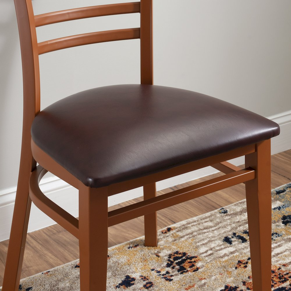 Set of two Start2Finish Baxter metal side chairs in honey and burgundy with curved metal frames and cushioned seats.