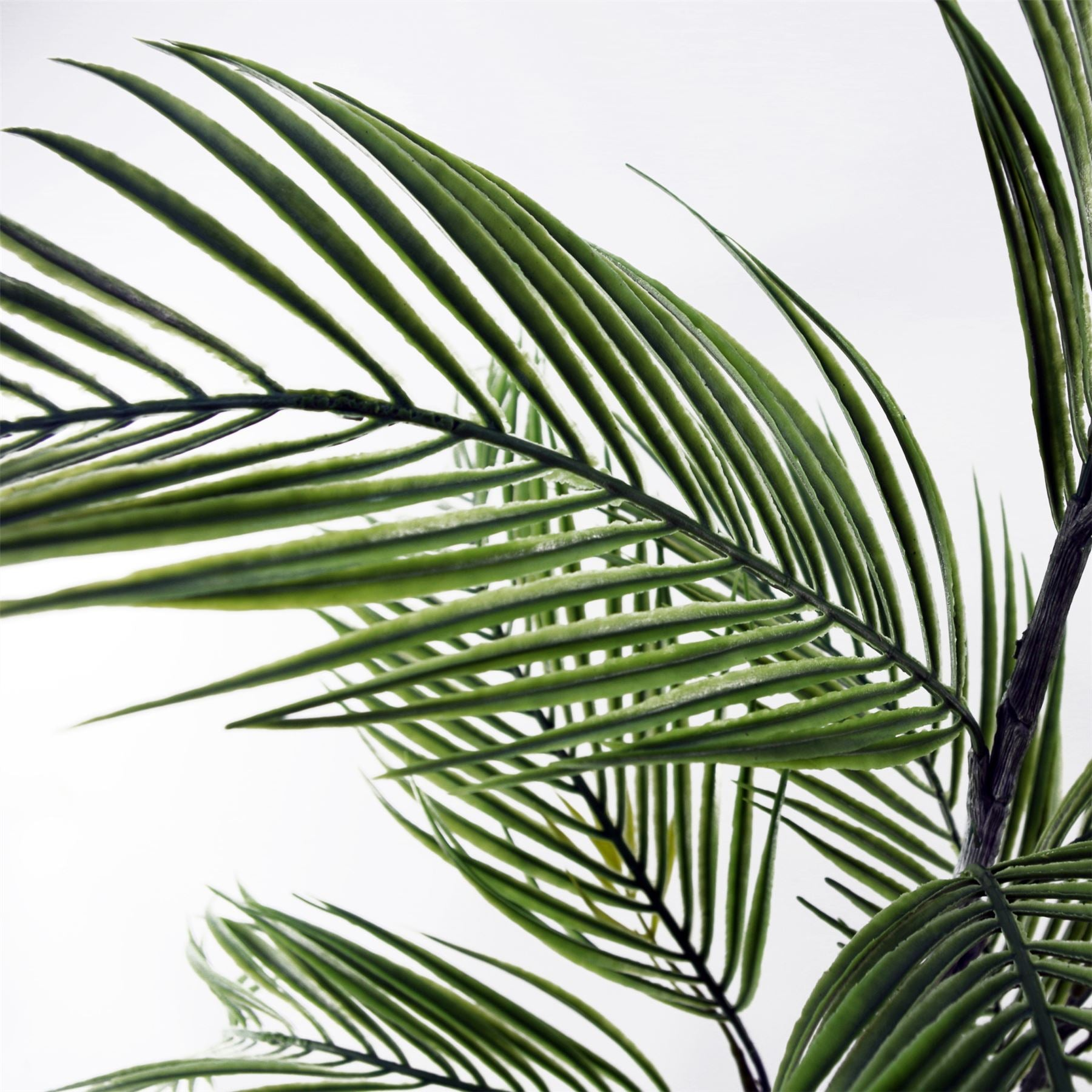 Artificial palm tree in decorative planter, showcasing lush green fronds and stylish base for home or office decor.
