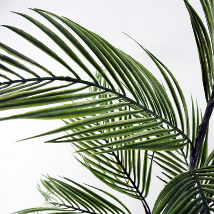 Artificial palm tree in decorative planter, showcasing lush green fronds and stylish base for home or office decor.