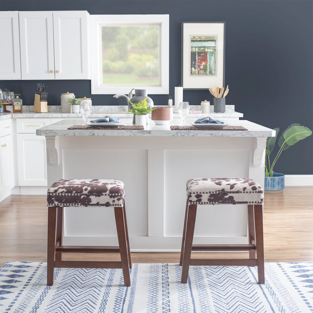 Walt Brown Cow Print Counter Stool by Start2Finish featuring a cushioned seat and cow print upholstery for kitchen or bar area.