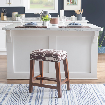 Walt Brown cow print counter stool by Start2Finish featuring a wooden frame and cow pattern upholstery for kitchen or bar area.