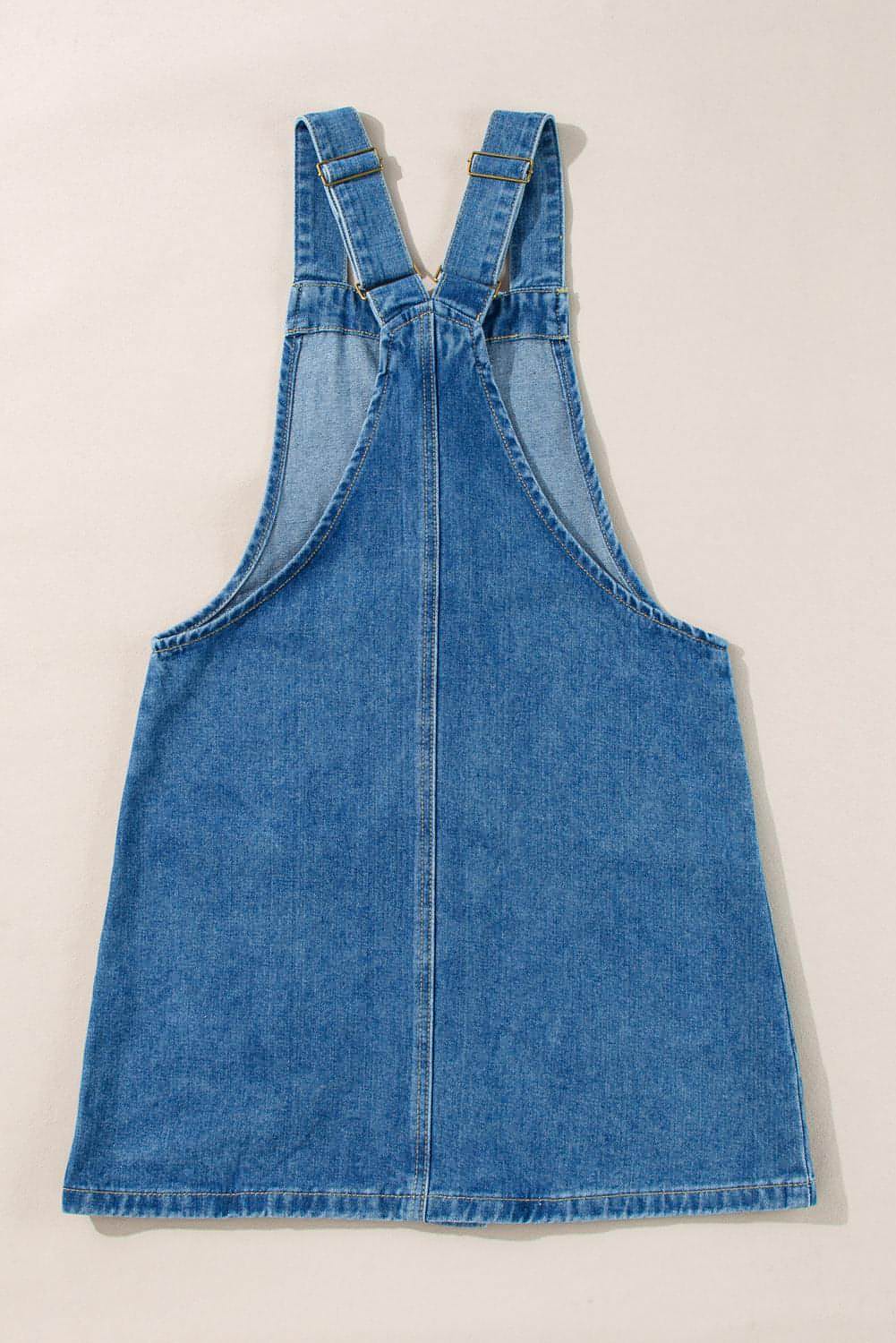 Dusk blue Carmine Juneberry denim mini dress with wide straps, button front, and front pockets, perfect for casual wear.