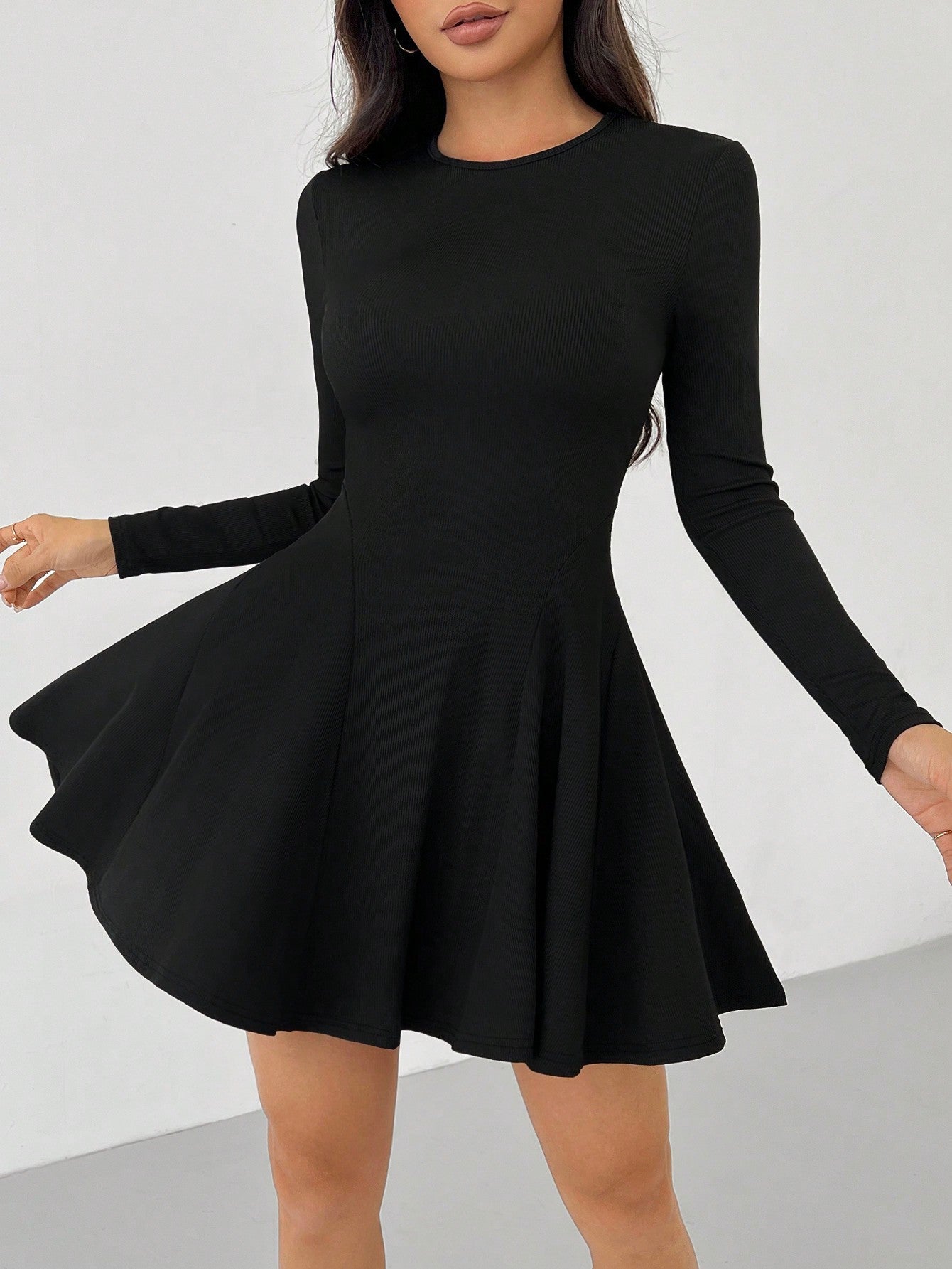 Green Alcestis dress with a flowing design, featuring a fitted bodice and wide skirt, perfect for elegant occasions.