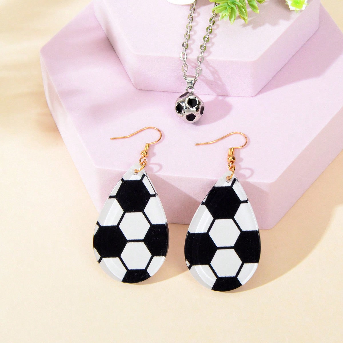 White Demeter sporty soccer pendant necklace and earrings set featuring soccer ball charms on silver-tone jewelry pieces.