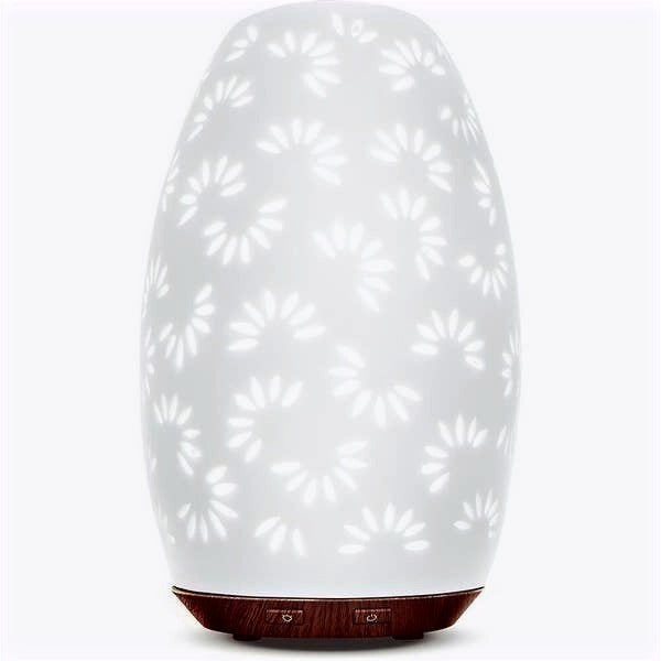 Yellow Shadow Daisy Essential Oil diffuser for bath and beauty, shown with floral decor and mist for relaxing aromatherapy.