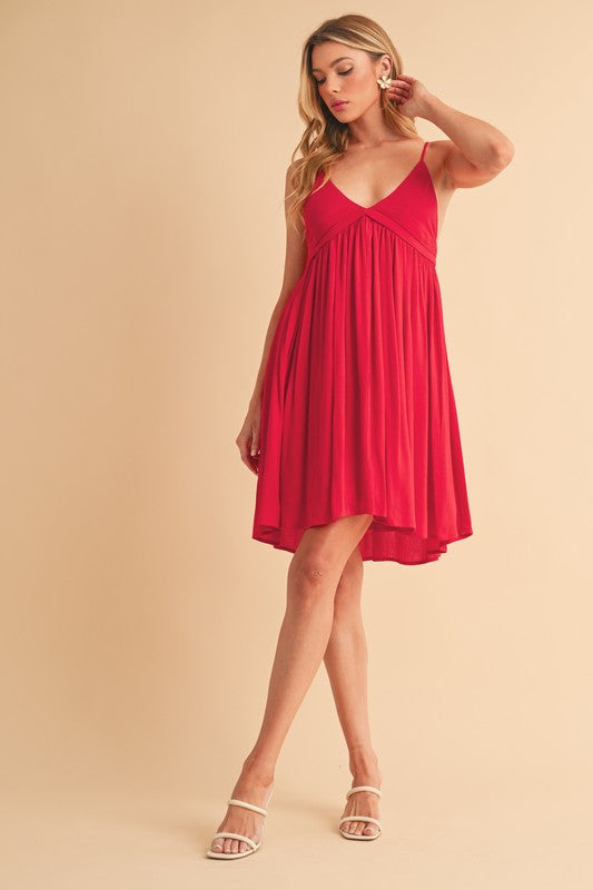 Jade Icarus Aemi + Co Ruched Plunge Mini Cami Dress in black, sleeveless with a fitted, ruched bodice and plunge neckline.