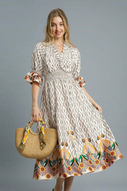 Umgee printed smocked waist flounce sleeve midi dress, light fabric with floral print, displayed on a hanger.