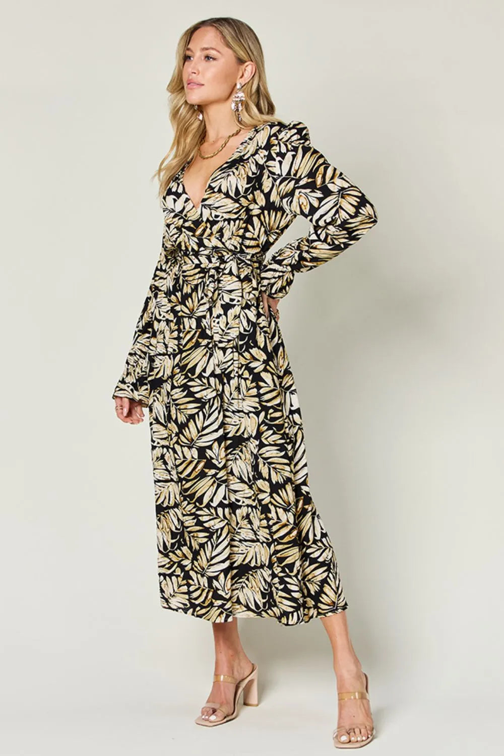 Pear Daisy Double Take full-size tie-back flounce sleeve dress displayed on a hanger in a home setting.