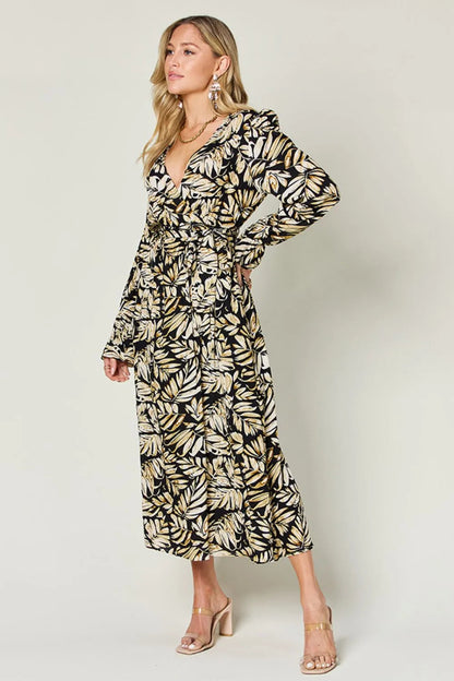 Pear Daisy Double Take full-size tie-back flounce sleeve dress displayed on a hanger in a home setting.