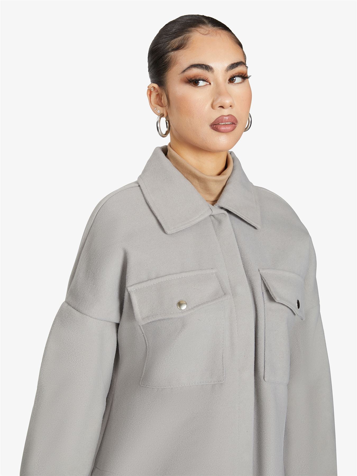 Rose Eleusis oversized longline shacket in neutral tone, showcasing a relaxed fit, collar, and button closure style.