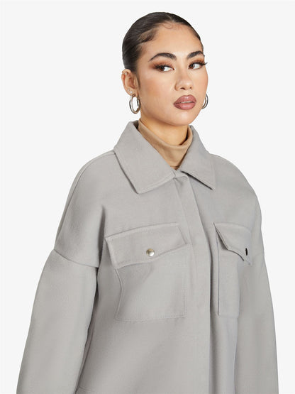 Rose Eleusis oversized longline shacket in neutral tone, showcasing a relaxed fit, collar, and button closure style.