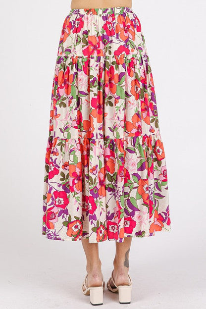 Colorful flower print elastic waist tiered skirt by Jade Icarus, showcasing its flowing fabric and vibrant floral pattern.